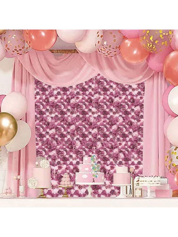 a pink and gold birthday party setup with balloons, cake and other items on the table