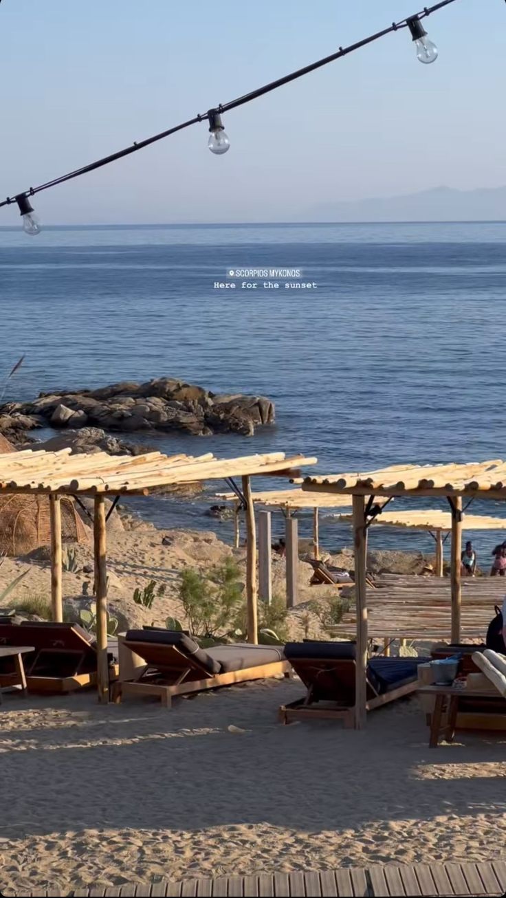 the beach is lined with lounge chairs and umbrellas