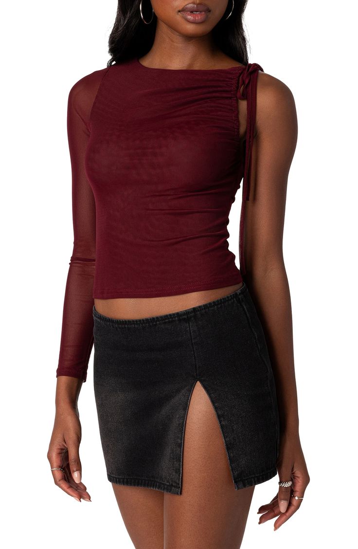 Rock an edgy night-out vibe in this asymmetric top designed with a single sheer sleeve and ruched accents. Jewel neck Single long sleeve 95% polyester, 5% spandex Machine wash, dry flat Imported Long Sleeve Going Out Tops, Burgundy Long Sleeve Tops For Night Out, Sheer Long Sleeve Flowy Top, Asymmetrical Mesh Top, Spring Asymmetrical Sheer Top, Edgy Sheer Stretch Mesh Top, Character Clothes, Asymmetric Top, Nails 2022