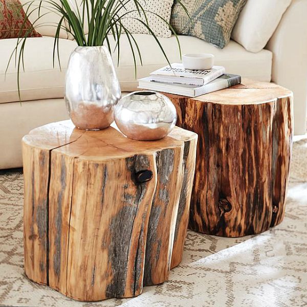 two wooden tables sitting on top of a carpeted floor next to a white couch