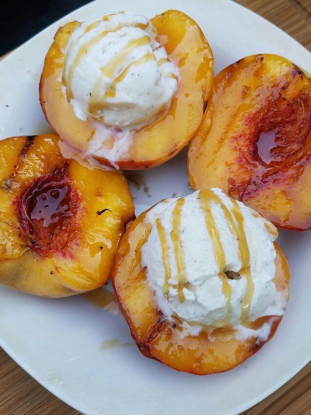 grilled peaches with whipped cream on top