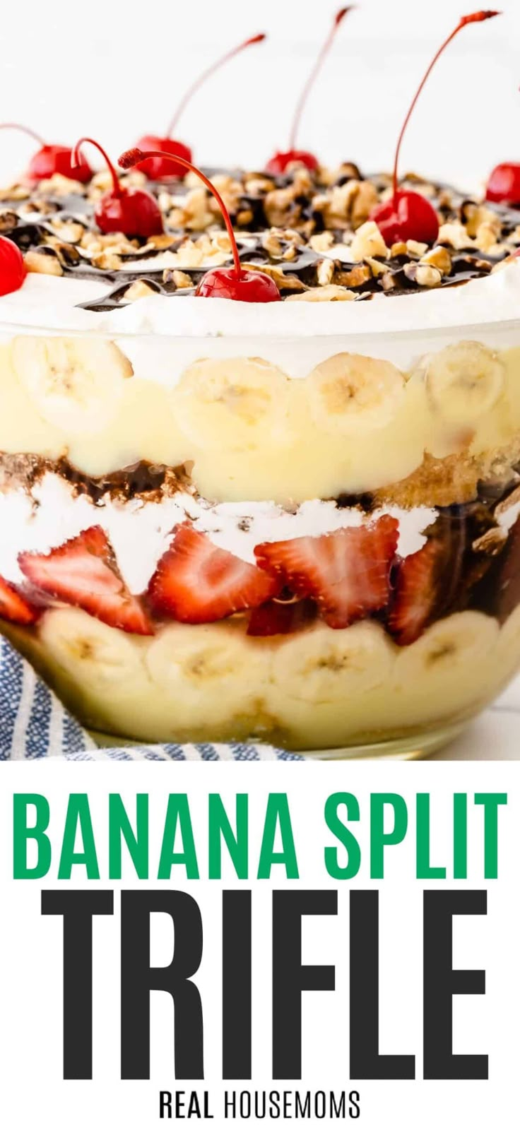 a banana split trifle with strawberries and cherries on top