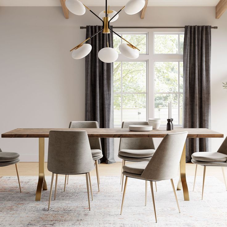 a dining room with a table, chairs and a chandelier hanging from the ceiling