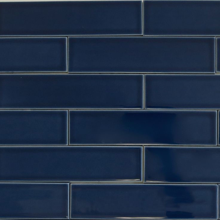 a dark blue brick wall that has been painted