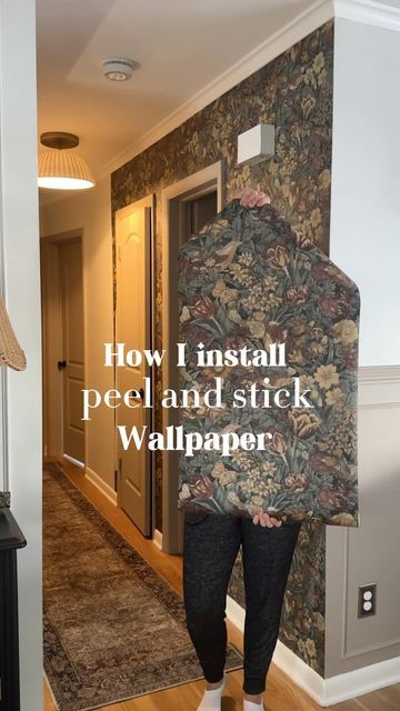 a person standing in front of a wallpapered hallway with the words how i install peel and stick wallpaper