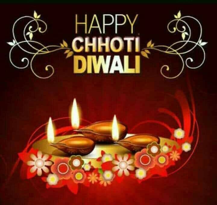 happy chhoti diwali with lit candles and flowers on a red background