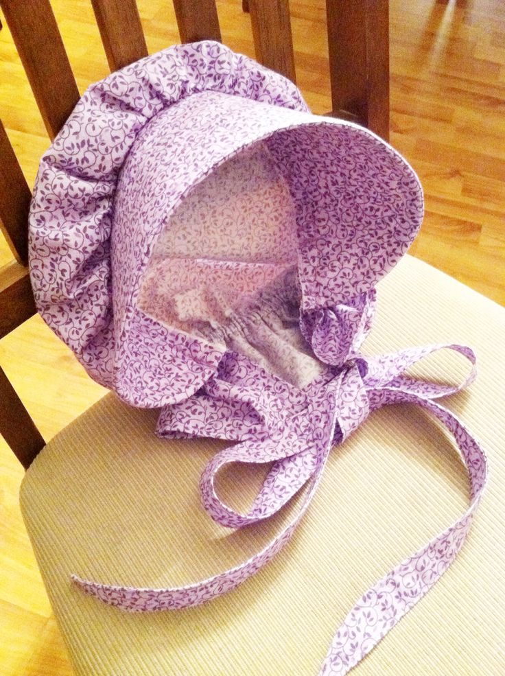 a purple bonnet sitting on top of a chair