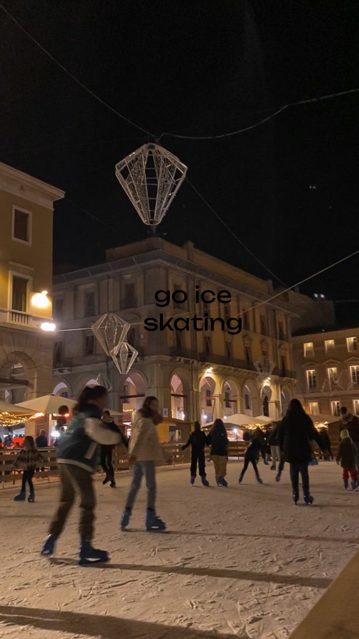 people skating on the snow in front of a building at night with an advertisement that reads go ice skating