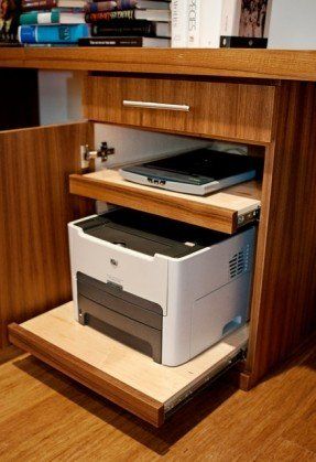 a computer and printer sitting on top of a wooden shelf