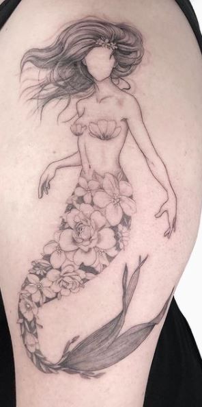 a woman with long hair and flowers on her stomach is depicted in this tattoo design