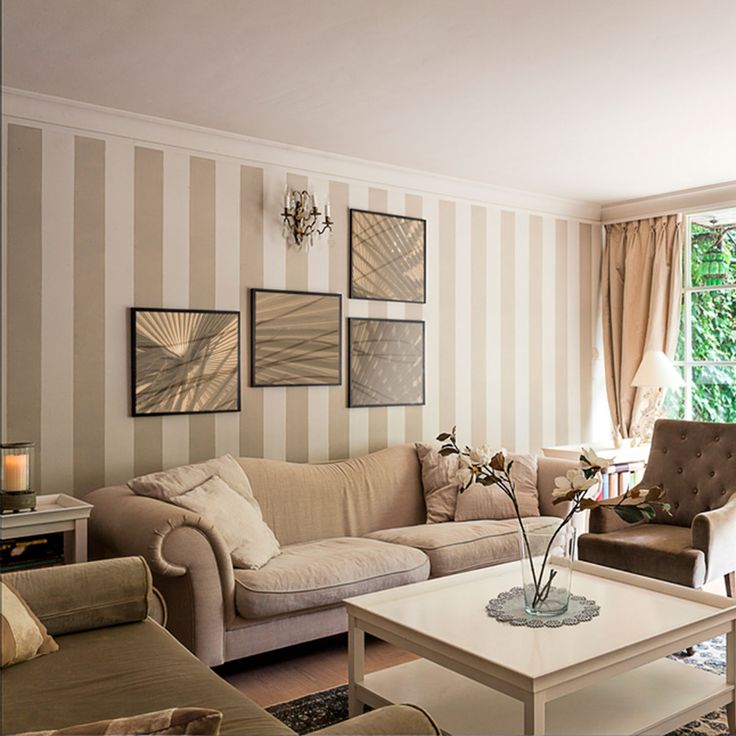 a living room filled with furniture and striped walls