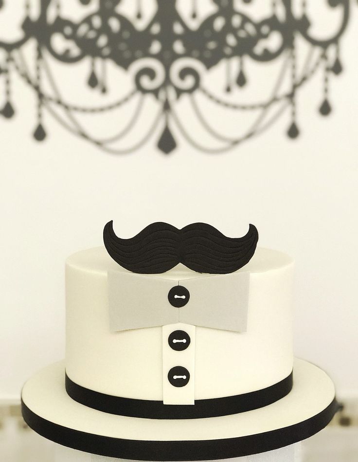 a white cake with a black mustache on top