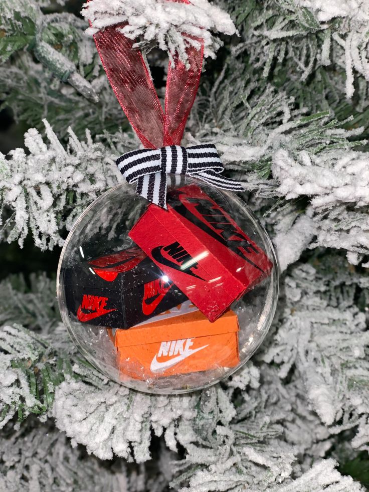 a christmas ornament hanging from a tree filled with candy and candies,