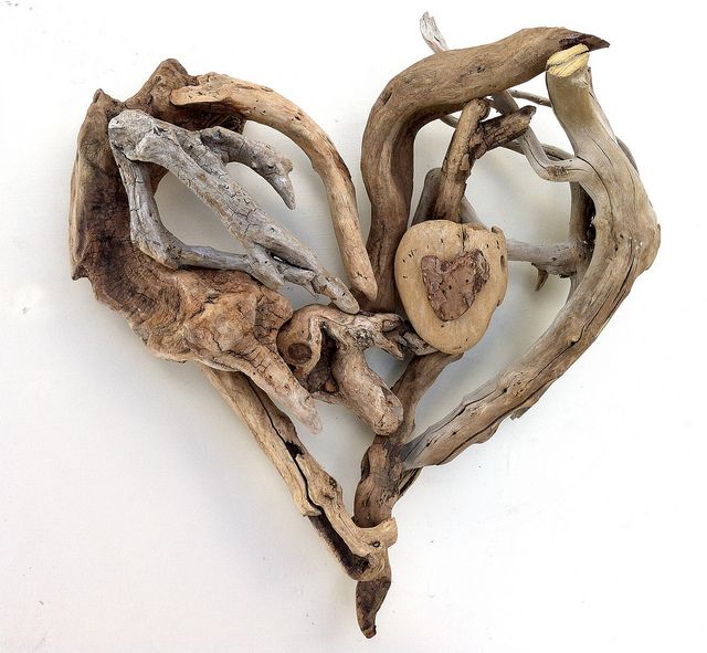 driftwood pieces arranged in the shape of a heart