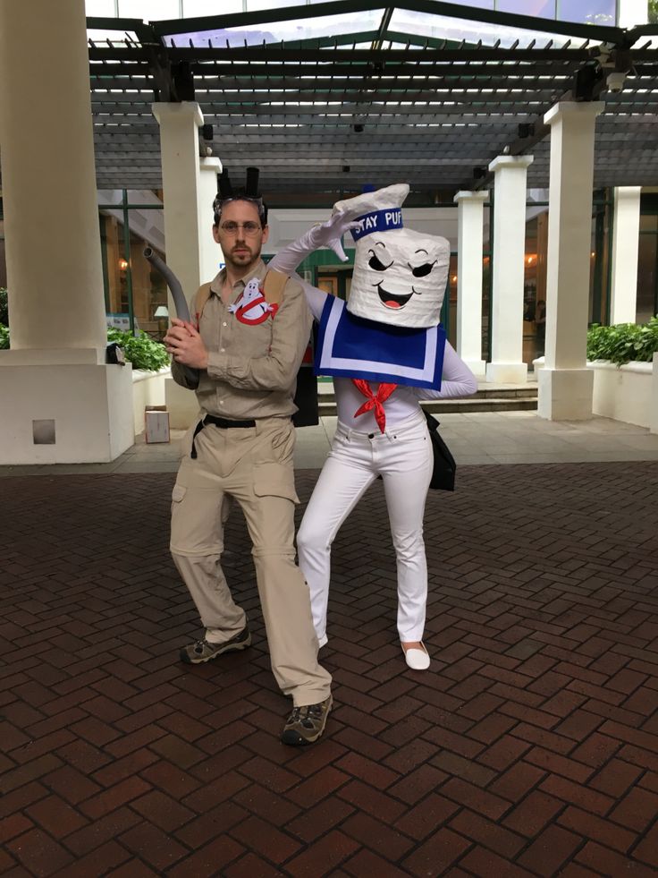 two people dressed in costumes posing for the camera