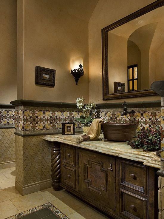 a bathroom with a sink, mirror and tiled walls in the background is an ornately decorated bathtub