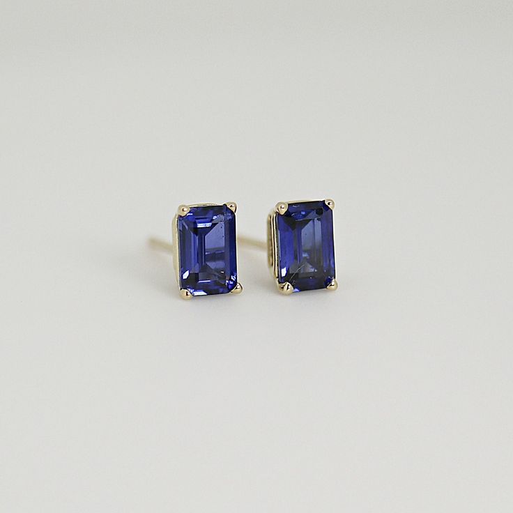 Elevate your style with our 14k Gold Emerald Cut Blue Sapphire Stud Earrings, perfect for adding a touch of sophistication and elegance to any outfit. These emerald cut sapphire stud earrings are the perfect size for everyday wear or special occasions, and their brilliant blue color is sure to catch the eye and make a statement. These exquisite studs feature genuine sapphire gemstones that are lab-grown for a sustainable and ethical choice. Unlike simulated or CZ stones, lab-grown sapphires are 14k Gold Sapphire Gemstone Earrings, Blue Emerald Cut Earrings For Formal Occasions, Classic Tanzanite Gemstone Earrings, Classic Baguette Cut Gemstone Earrings, Modern Emerald Cut Gemstone Earrings, Blue Emerald Cut Earrings For Gift, Classic Sapphire Birthstone Earrings, Modern Emerald Cut Earrings For Gift, Classic Blue Earrings For Everyday