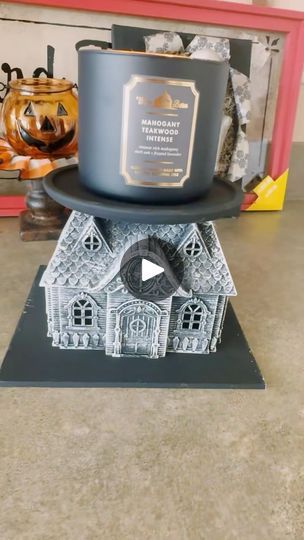 a candle is sitting on top of a house