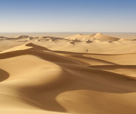 sand dunes in the desert with blue sky