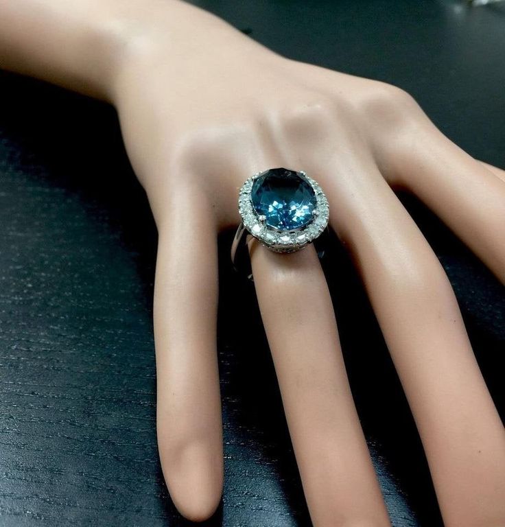 13.20 Carats Natural Impressive LONDON BLUE TOPAZ and Diamond 14K White Gold Ring Suggested Replacement Value $7,300.00 Total Natural London Blue Topaz Weight: 12.00 Carats London Blue Topaz Measures: 16.00 x 12.00mm Natural Round Diamonds Weight: 1.20 Carats (color G / Clarity SI1) Ring total weight: 8.4 grams Disclaimer: all weights, measurements and colors are approximate and may vary slightly from the listed dimensions or as seen in the image. All pictures are magnified to show the smallest Luxury Platinum Topaz Gemstone Ring, Luxury Round Gemstones With Diamond Accents, Luxury Platinum Topaz Ring With Accent Stones, Luxury Blue Topaz Ring In Platinum, Formal Aquamarine Diamond Ring With Brilliant Cut, Luxury Platinum Topaz Ring With Halo Setting, Aquamarine Brilliant Cut Diamond Ring For Formal Occasions, Exquisite Diamond Topaz Ring For Formal Occasions, Luxury Formal Blue Topaz Diamond Ring