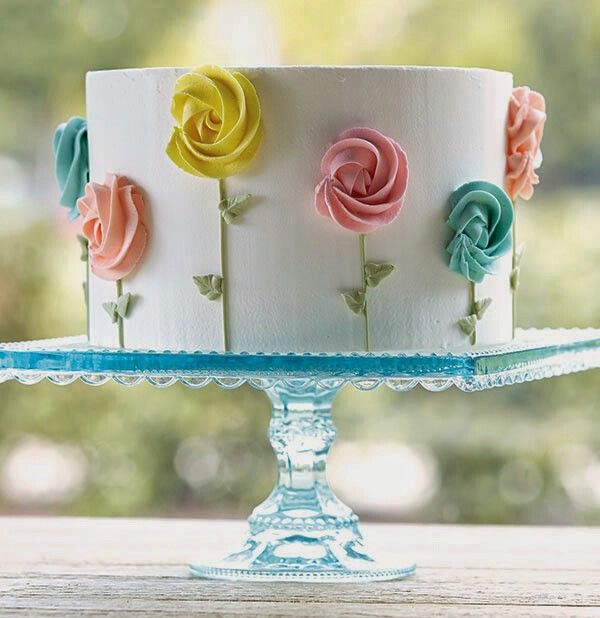 a white cake with colorful frosting flowers on it and the words you can do this we show you how