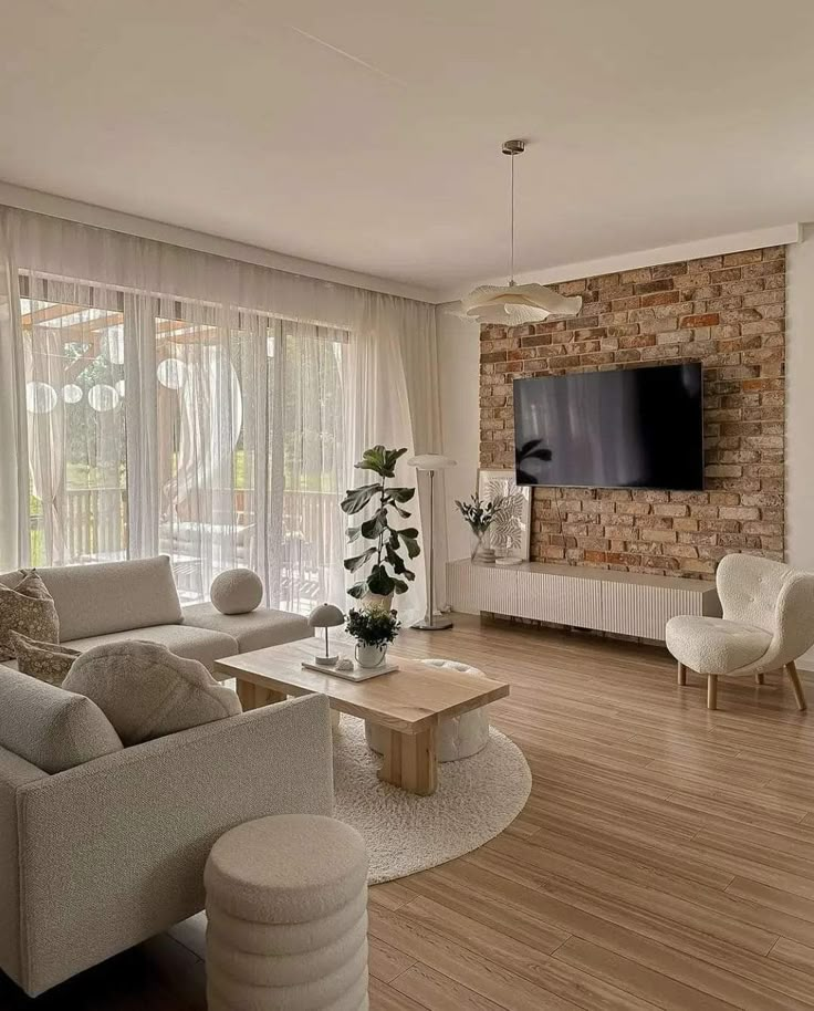 a living room filled with furniture and a flat screen tv mounted on the wall above a fireplace