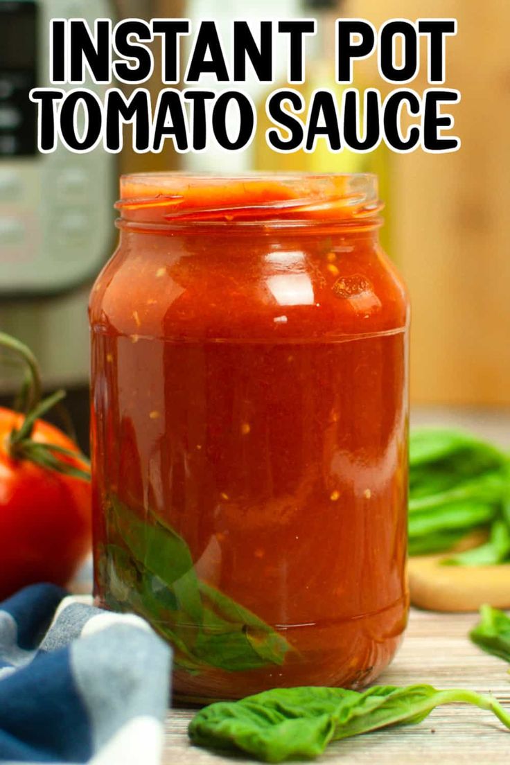 a jar filled with tomato sauce sitting on top of a wooden table next to vegetables