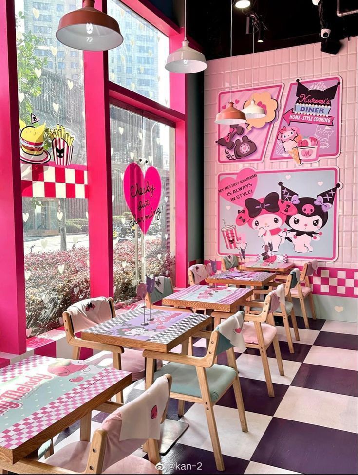 an empty restaurant with pink walls and checkered tables