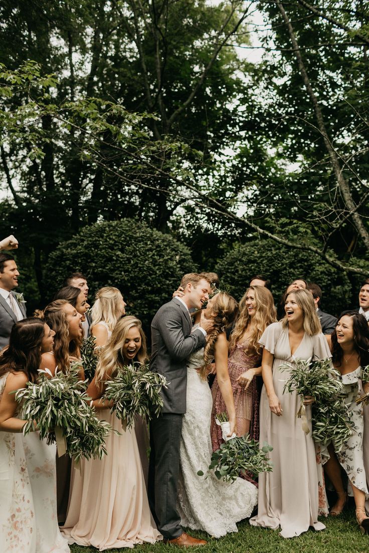 a group of people standing next to each other on top of a lush green field