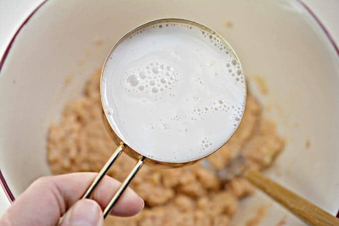 a person is holding a magnifying glass with cereal in it