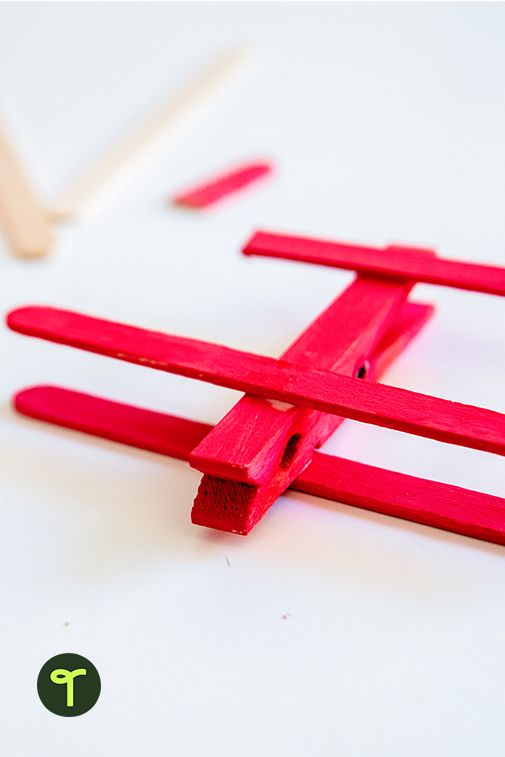 popsicle sticks are arranged in the shape of a cross on a white surface with text overlay that reads, popsicle sticks