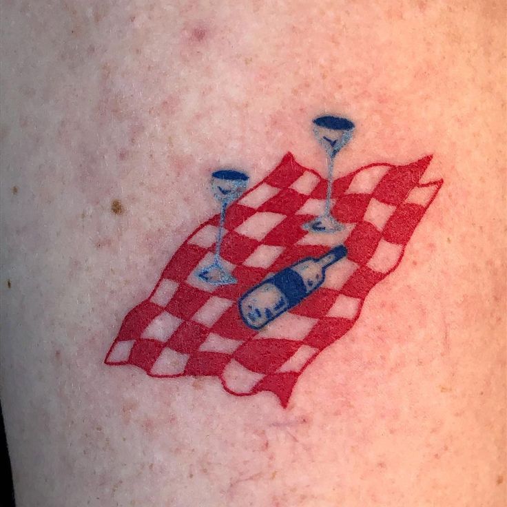 a red and white checkered flag with two wine glasses on it