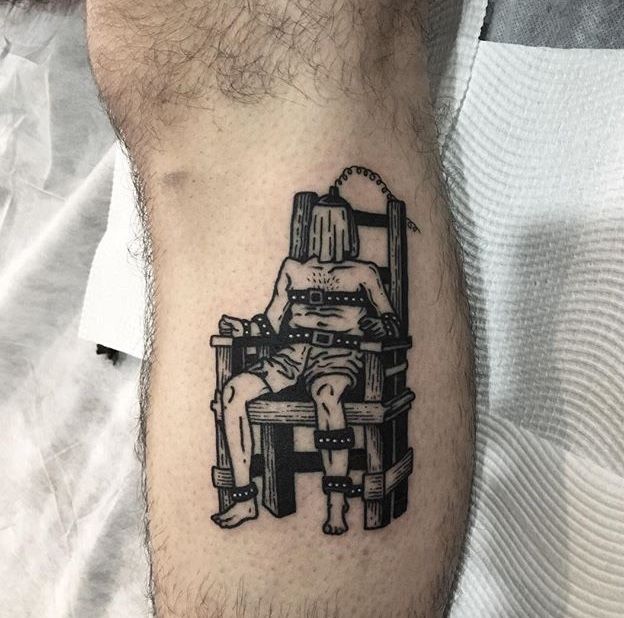 a black and white tattoo of a man sitting in a chair