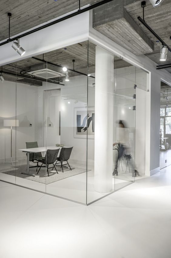 an office with glass walls and white floors