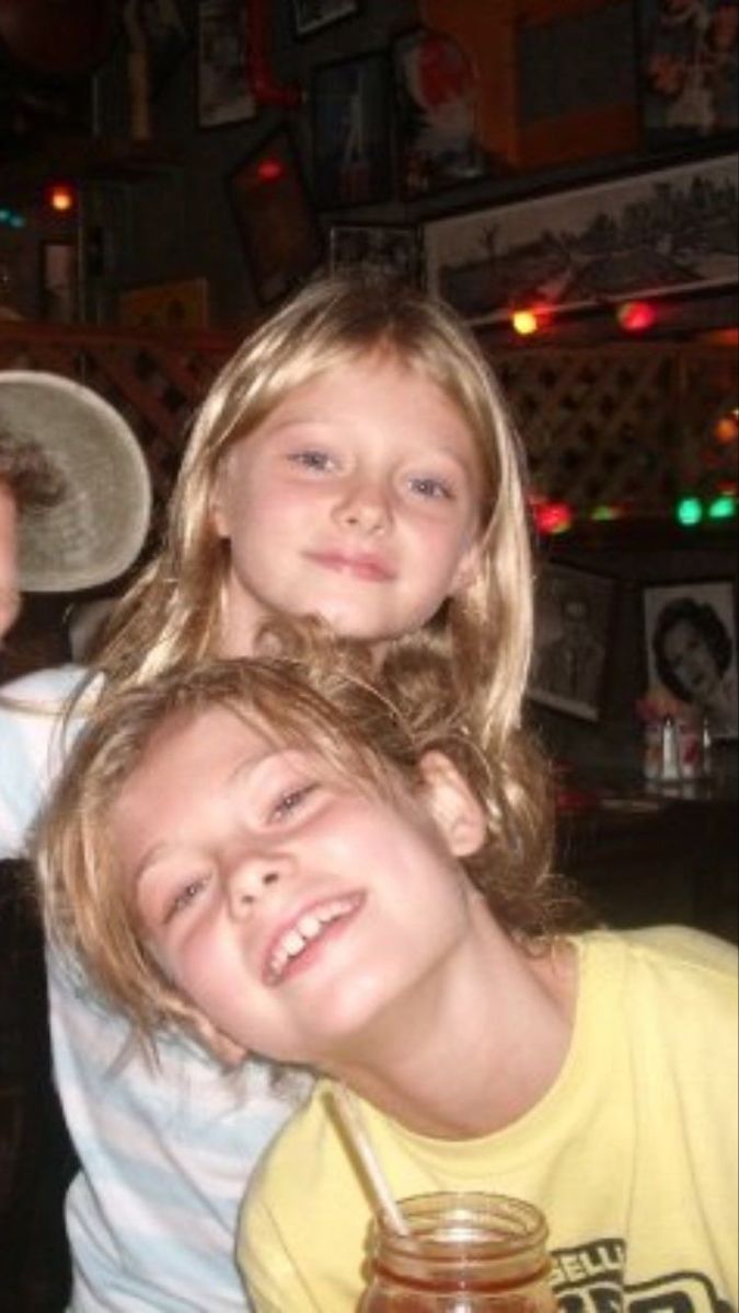 three children are posing for the camera with their arms around each other in front of a bar