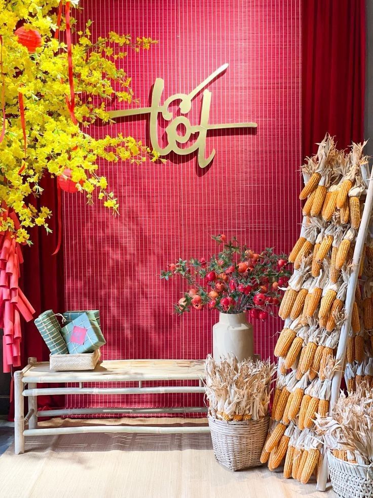 there is a red wall with yellow flowers in the corner and some baskets on the floor next to it