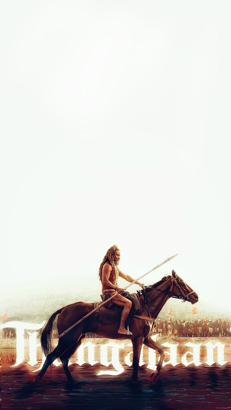 a man riding on the back of a brown horse