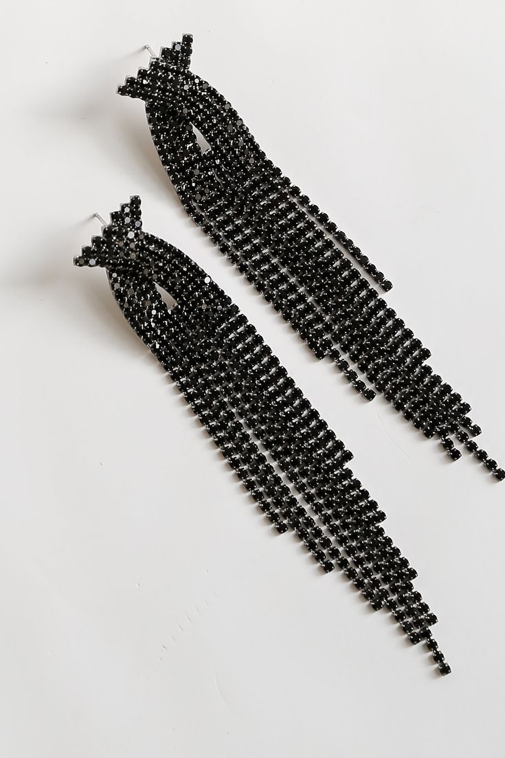 The Dakota Black Rhinestone Fringe Earrings will add some extra sparkle to any occasion! These trendy earrings start with a stud post back and fall to rhinestone fringe chains. Add these fun earrings to a black dress + heels to add a chic touch to your date night look! Gold Plated Rhinestones Fringe Stud Post Back One Size | Length 4” Chic Crystal Earrings With Rhinestones For Party, Chic Party Crystal Earrings With Rhinestones, Elegant Black Chandelier Earrings For Party, Black Dangle Chandelier Earrings For Party, Black Chandelier Drop Earrings For Evening, Trendy Rhinestone Earrings For Evening, Trendy Evening Dangle Chandelier Earrings, Glamorous Black Evening Earrings, Black Dangle Earrings For Party