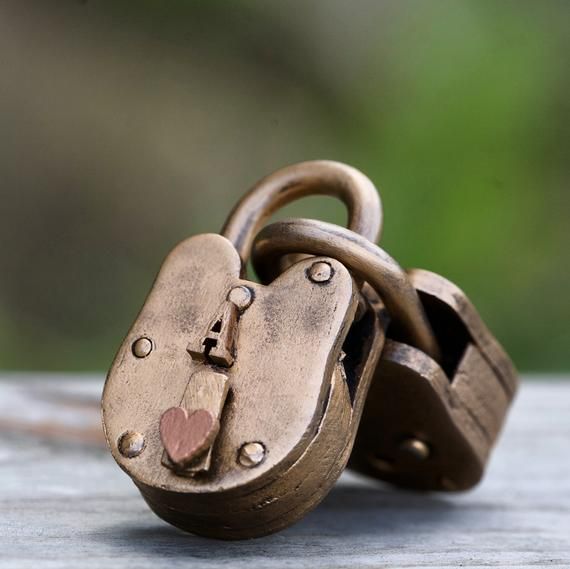 an old padlock with two hearts on it