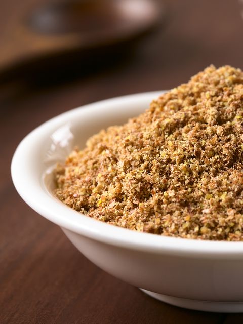 a white bowl filled with food on top of a wooden table