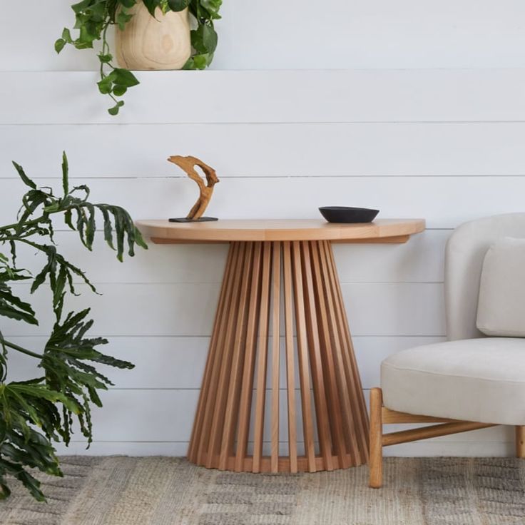 a chair next to a table and potted plant