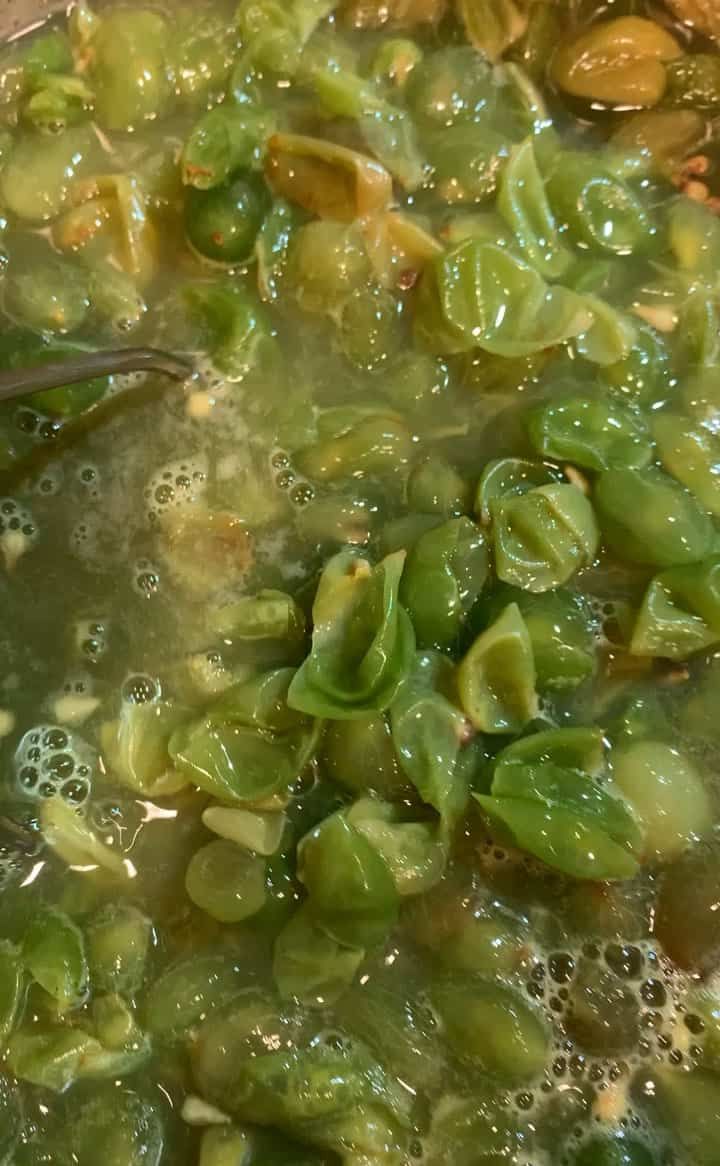 a pot filled with green beans and broth