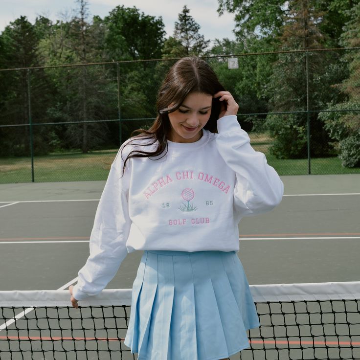 Tee off in style with this preppy crew! This crew is perfect for spilling the tea in with your girls or practicing your swing in on a summer night. Pair with your favorite golf skirt or cheer skirt for a cute summer outfit. This crew will have your sorority name embroidered in pink thread above your established year and a cute golf ball on the tee. Model is wearing a size large White crew with bright pink and green embroidery Casual Cotton Tennis Skirt For Cheerleading, Preppy Blanket, Southern Preppy Outfits, Sorority Names, Preppy Southern, Golf Skirts, Cute Summer Outfits, Preppy Outfits, Golf Clubs