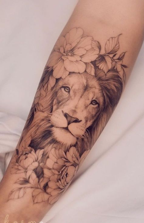 a woman's arm with a lion and flowers on it