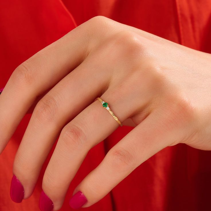 Elevate your style with this Emerald Minimal Solitaire Ring by Lucy Jewelry. Crafted in 14k solid gold, it features a dainty twisted band that leads to a brilliant emerald solitaire. This ring exudes elegance and sophistication, making it an ideal choice for a promise ring, engagement ring, or a unique addition to your jewelry collection. Features * 14k Solid Gold * Band Options; Yellow Gold, White Gold Rose Gold * Top Width: 6.00x2.25 mm * Band Width: 1.55 mm * Thickness: 1.15 mm * Gemstone: Ge Emerald Promise Ring Simple, Fine Jewelry Stackable May Birthstone Rings, 14k Gold Emerald Open Ring For Promise, 14k Gold Emerald Birthstone Ring, Dainty Emerald Promise Ring, Stackable Rings As May Birthstone Promise Ring, Yellow Gold Birthstone Ring For May, Emerald Ring Simple, Dainty Promise Ring