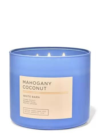 a blue candle that is sitting in front of a white background with the words mahogany coconut written on it