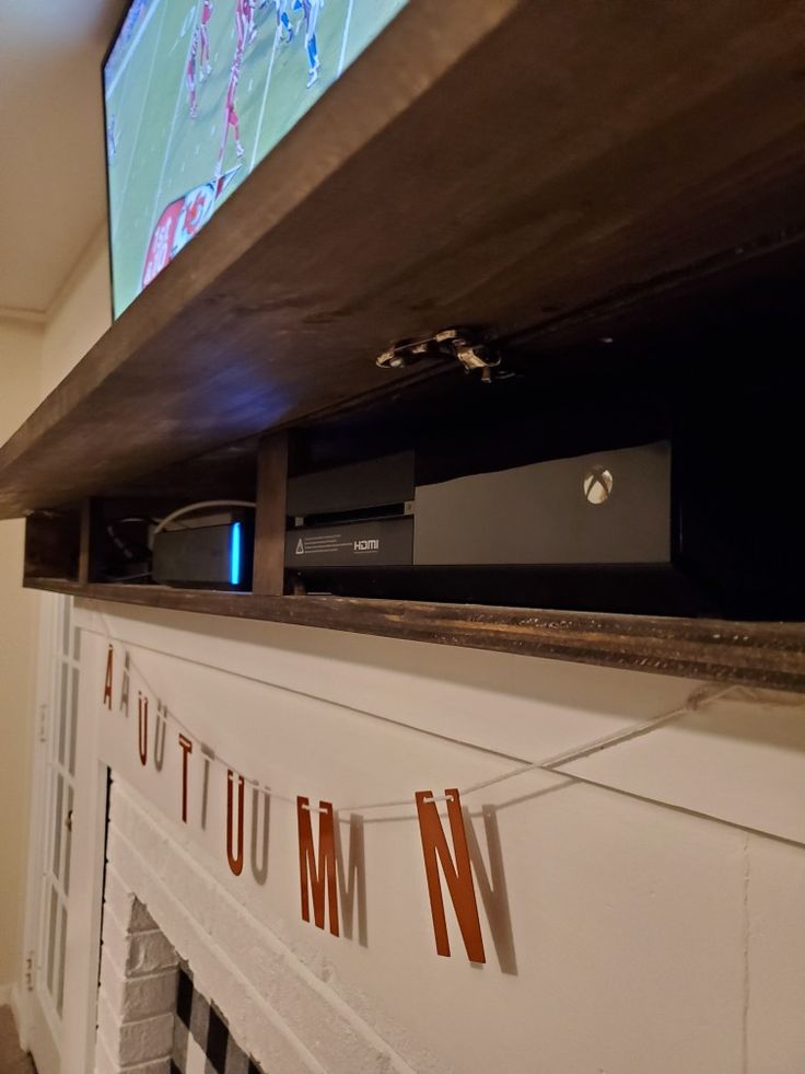 a flat screen tv mounted above a fireplace