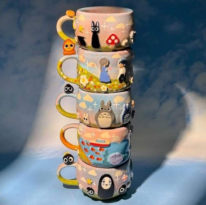 a stack of coffee mugs sitting on top of each other in front of a blue sky