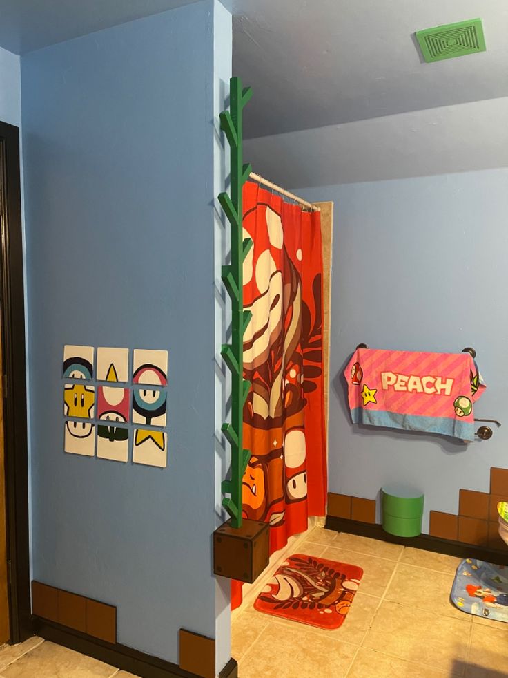 a bathroom with blue walls and pictures on the wall