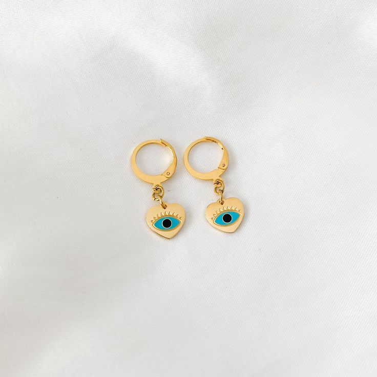 "Dainty mini hoop earrings featuring a blue evil eye heart charm ❀❀ INFO: ❀❀ ➳ Hoop size: 12.5 mm x 14.5 mm ➳ Evil eye charm size: 10mm ➳ Gold plated stainless steel material ➳ Non-tarnish ➳ Evil eye is known to repel evil spirits and keep you safe from harm ➳ Blue is the color of protection, radiates positive energy and good karma ❀❀ RETURN POLICY: ❀❀ Please note that because of health/hygiene concerns, earrings cannot be returned or exchanged ❀❀ VIEW MORE EARRINGS: ❀❀ https://www.etsy.com/shop Health Hygiene, Good Karma, Mini Hoop Earrings, Summer Inspo, Blue Evil Eye, Evil Eye Charm, Evil Spirits, Evil Eye Jewelry, Jewelry Earrings Hoops